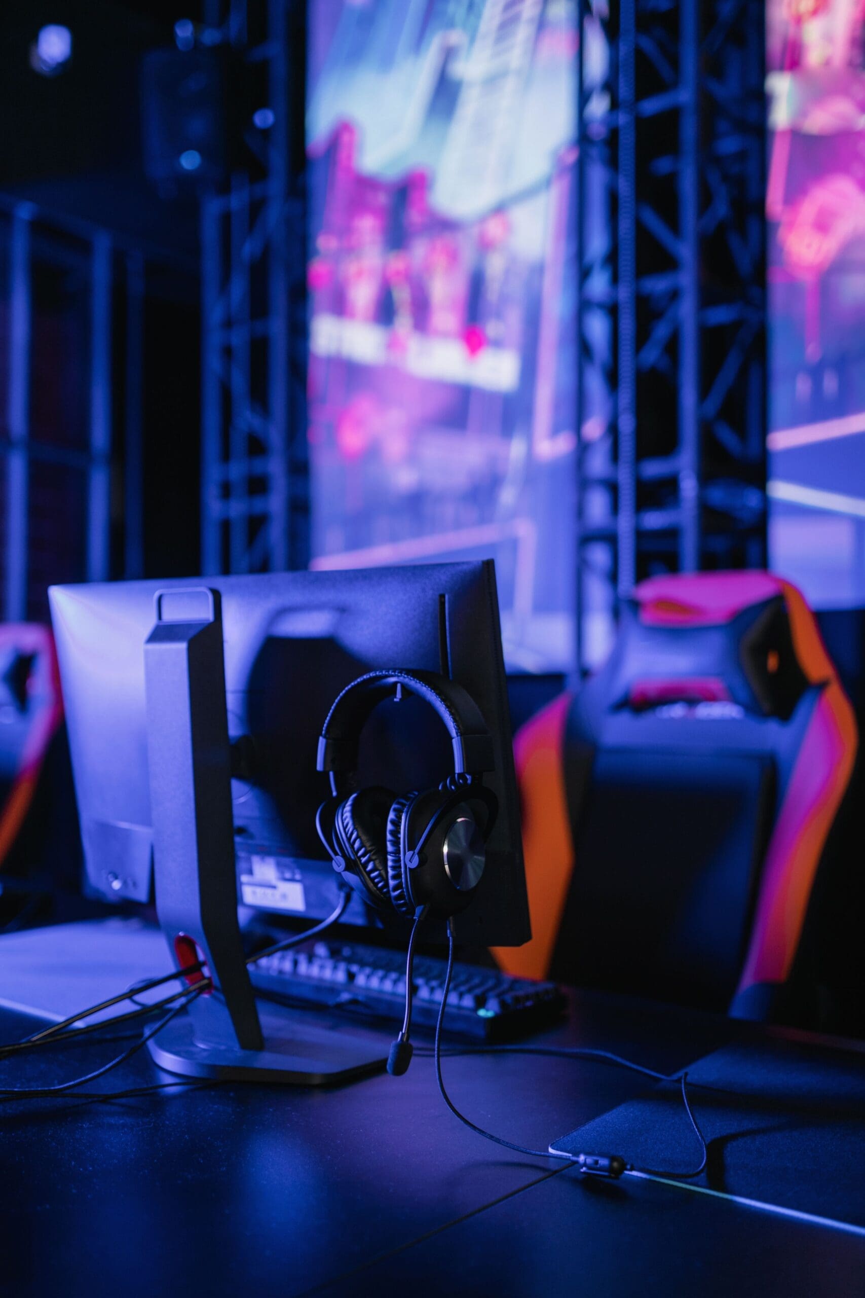 Gaming lounge PC station with neon lighting and gaming headset